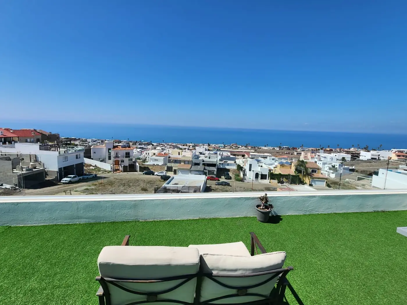 View from the Rite of Passage Mexico rooftop in Rosarito, Baja California &mdash; residential rooftops descending toward the Pacific Ocean